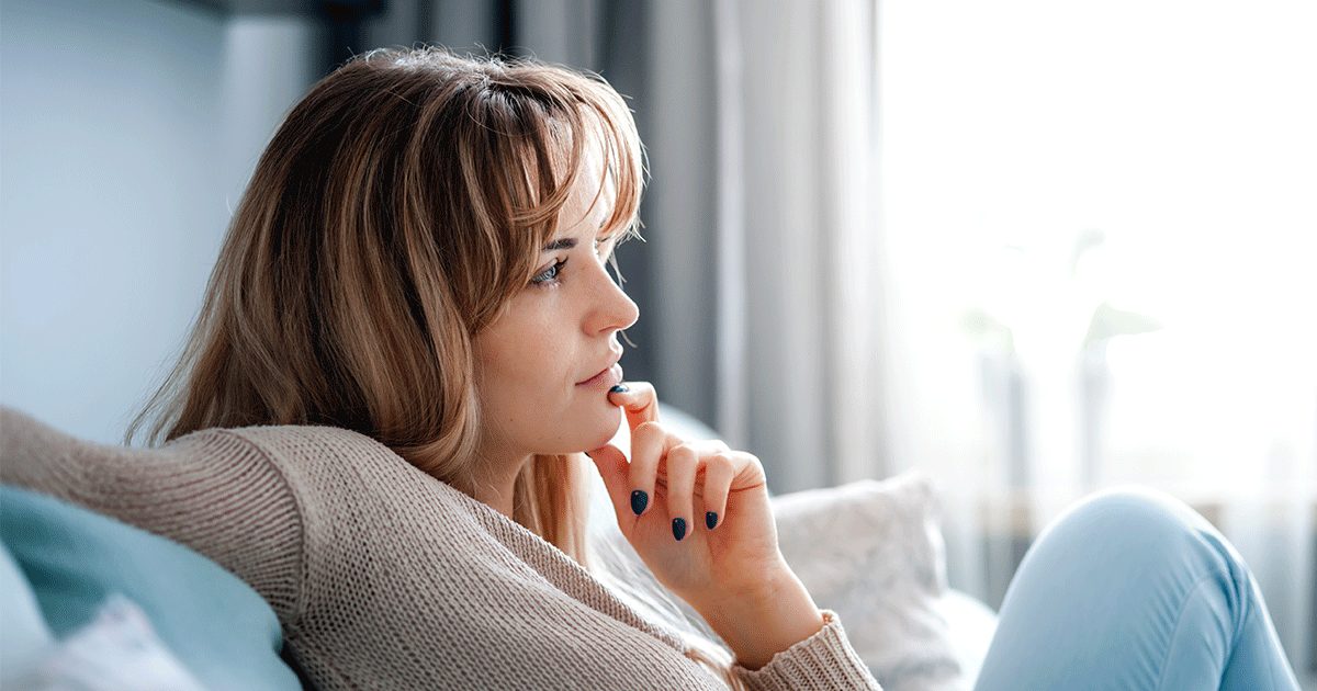 a woman thinking about her next step after finding out she's pregnant